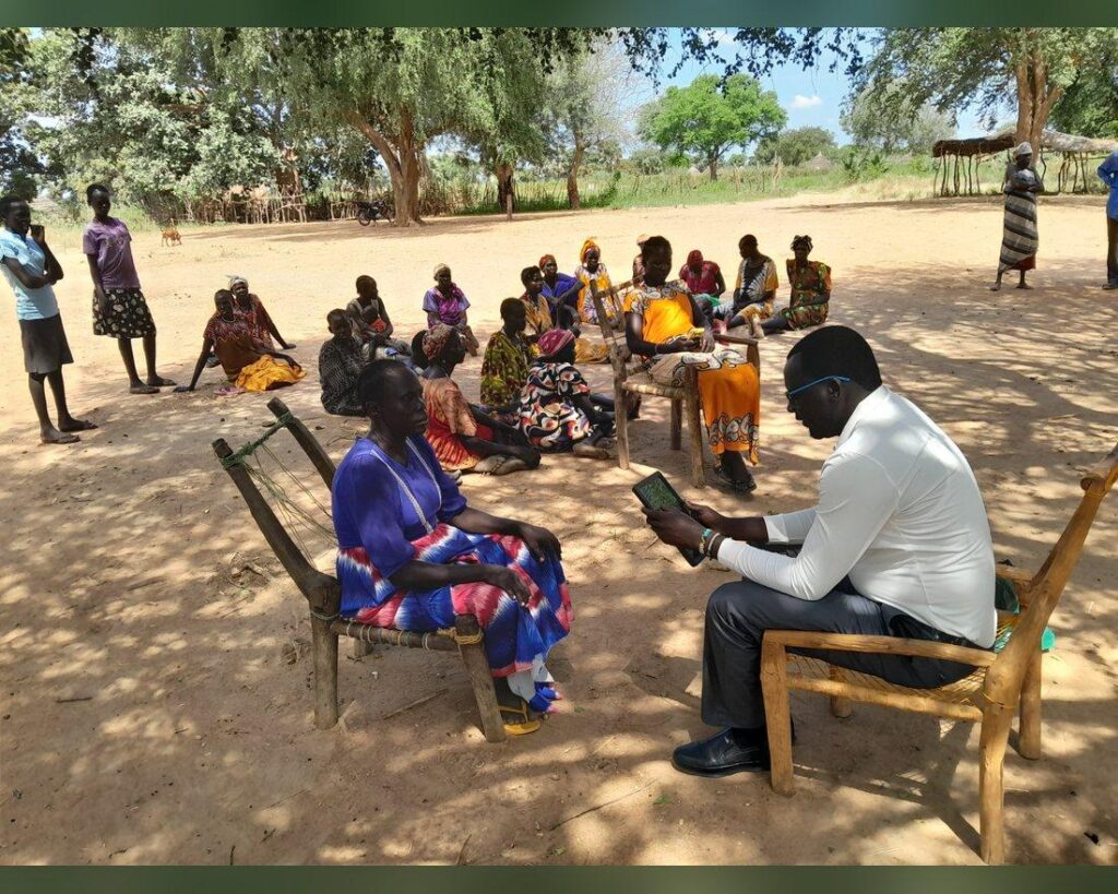An ALDO field training session with community members under the trees