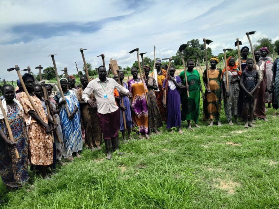 A women's farming group assembles for work
